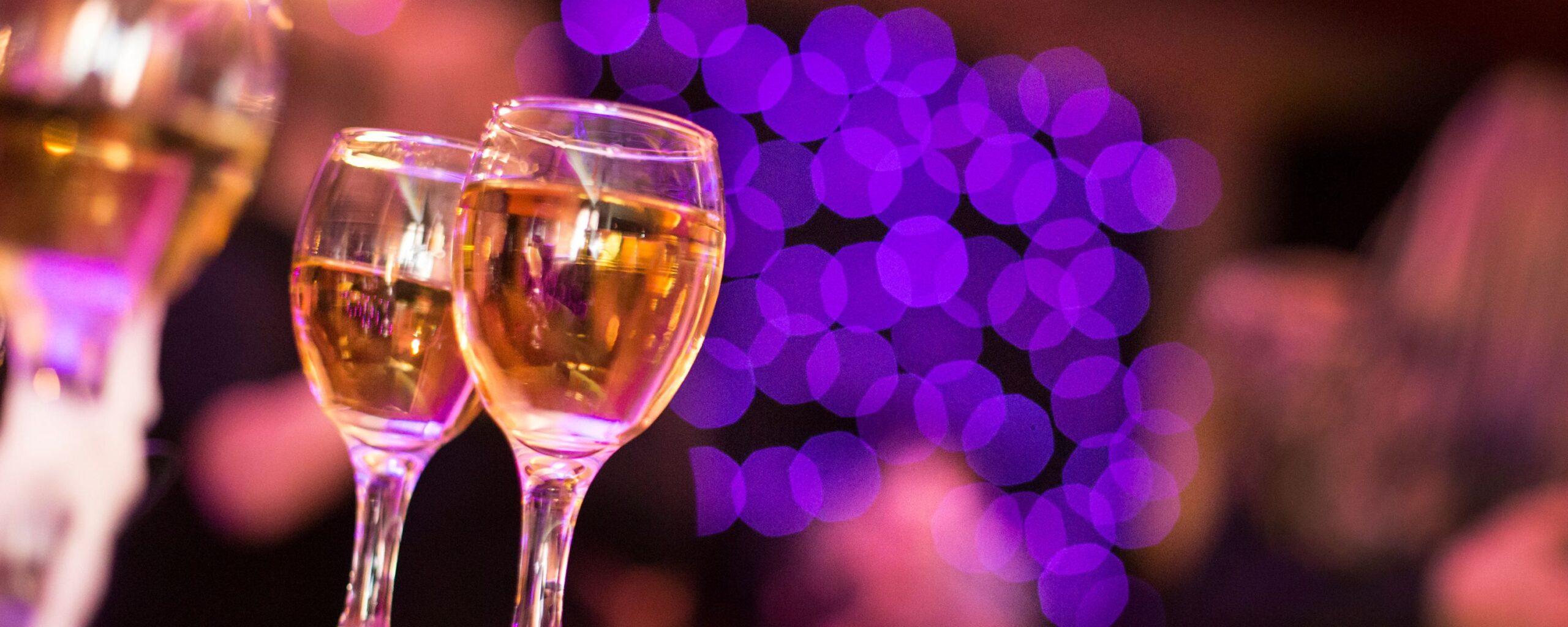 champagne with  purple lights in background