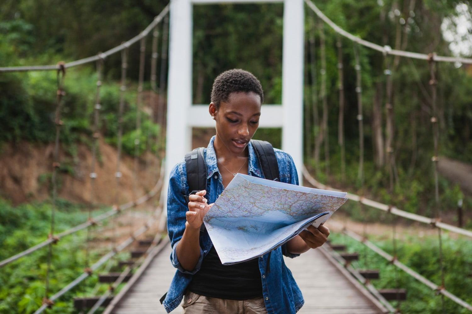 Someone reading map on bridge