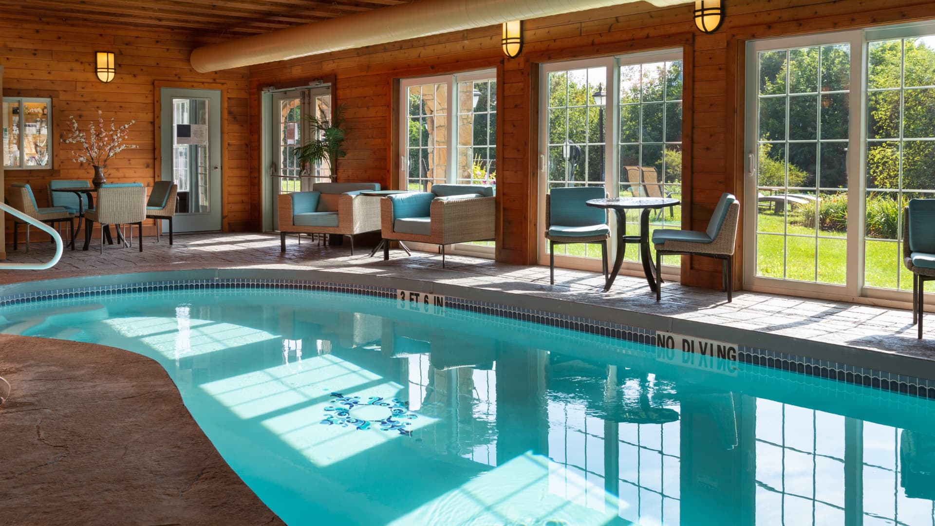 Indoor pool, wood walls and pool furniture