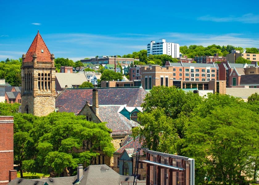 A scenic view of a city skyline featuring historic buildings and lush greenery under a clear blue sky. A scenic view of a city skyline featuring historic buildings and lush greenery under a clear blue sky.