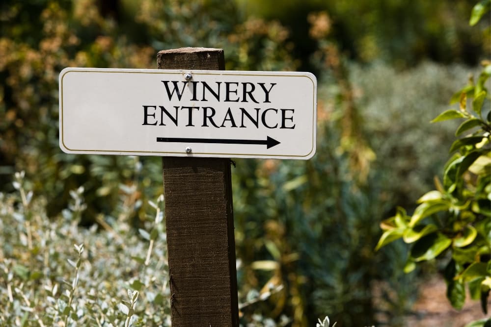 A sign at a vineyard that says Winery Entrance
