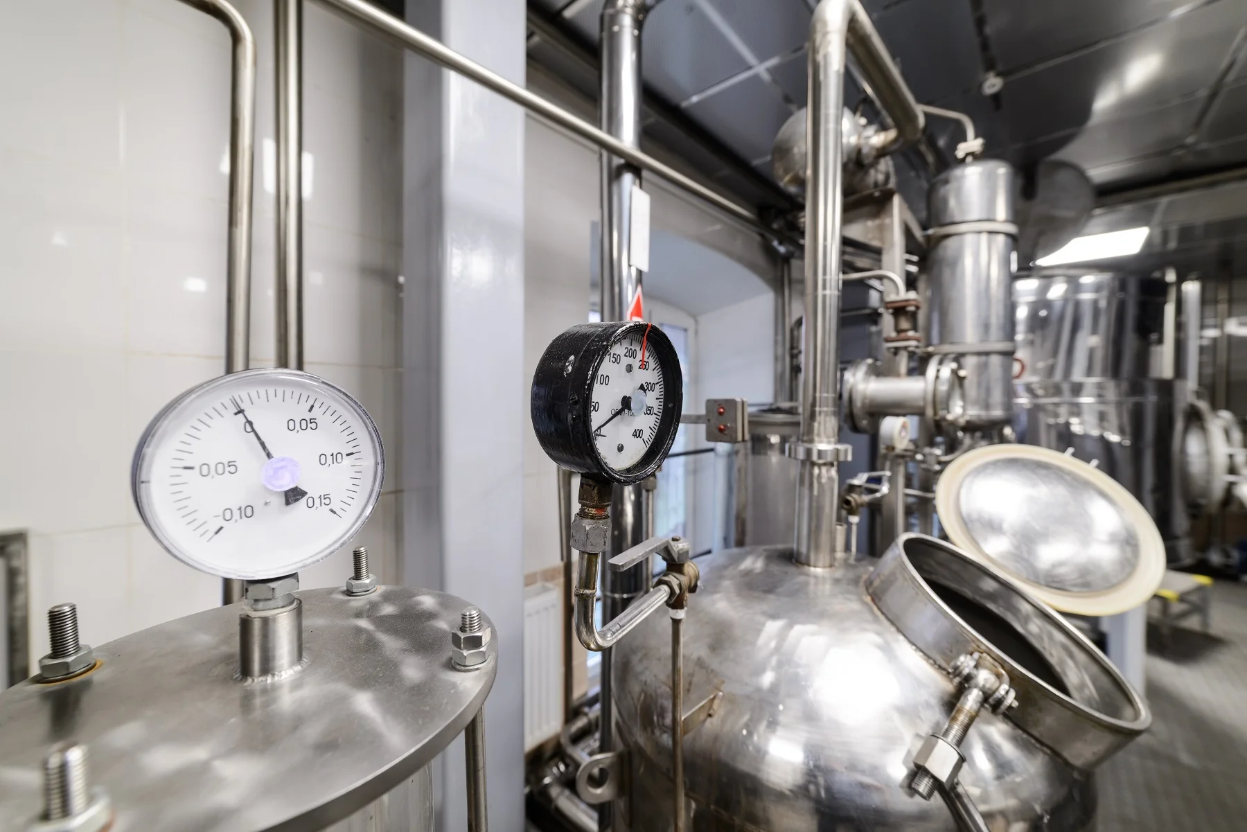 Industrial machinery with metal pipes and pressure gauges.