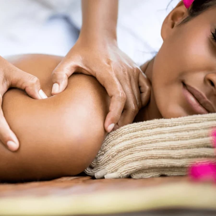a woman lying on a table getting a back massage