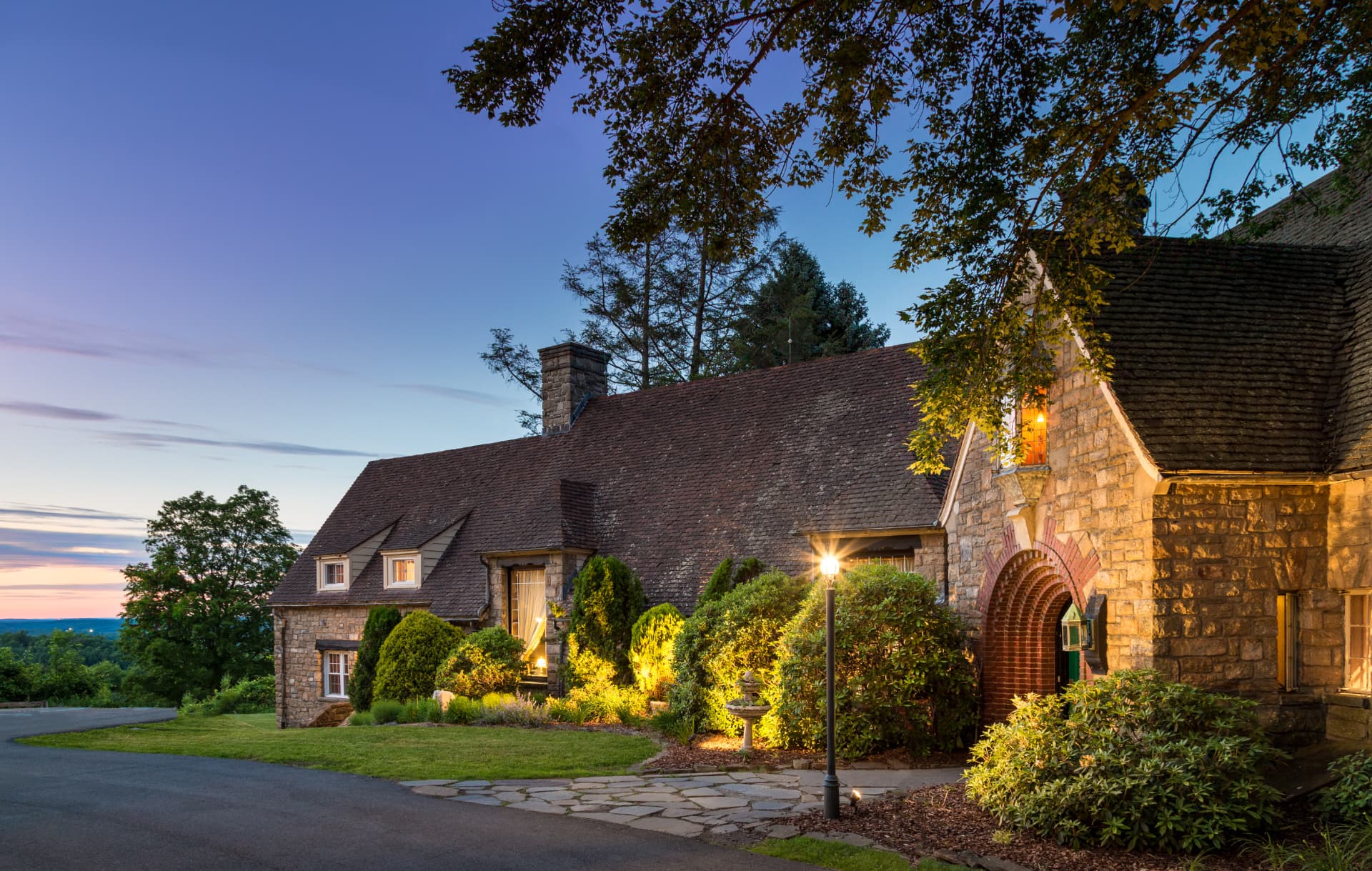 Exterior of inn - french country design with green grass